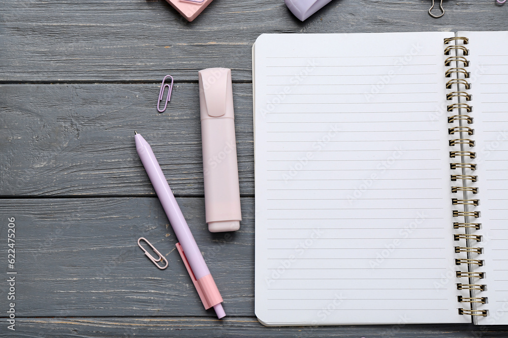 Blank notebook with different stationery on grey wooden background