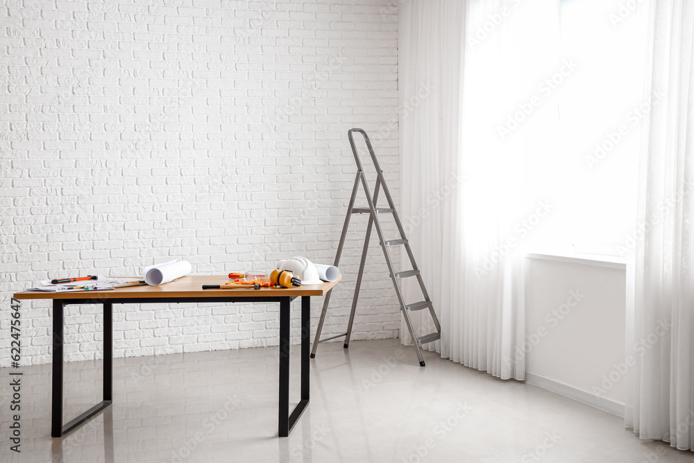 Table with builders supplies in room