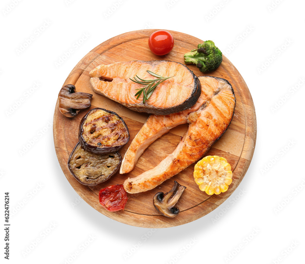 Wooden board with tasty grilled salmon steaks and vegetables on white background