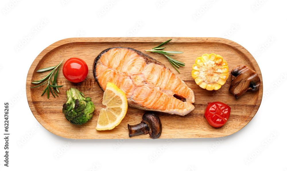 Wooden board with tasty grilled salmon steak, lemon and vegetables on white background