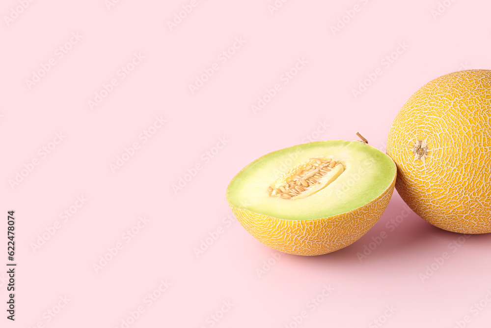 Sweet melon with half on pink background