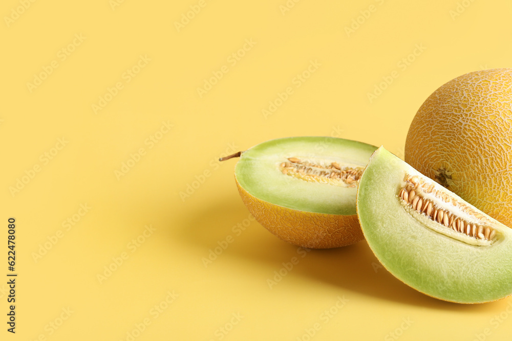 Sweet melon with pieces on yellow background