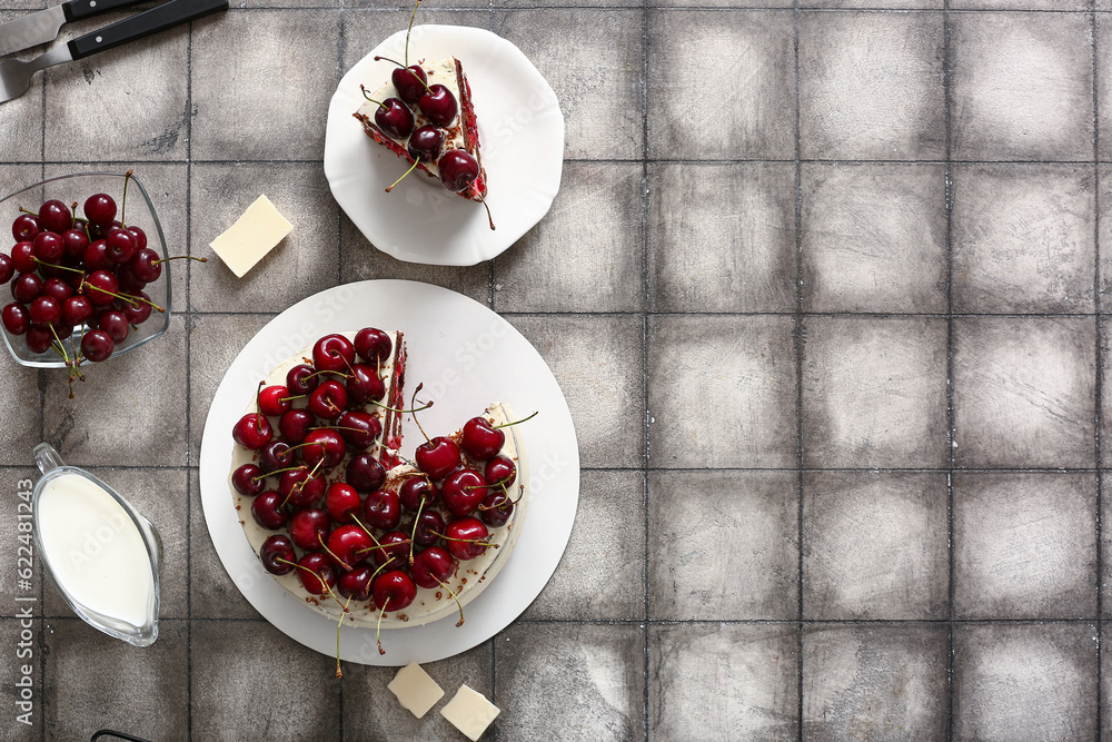 Tasty cherry cake on grey tile background