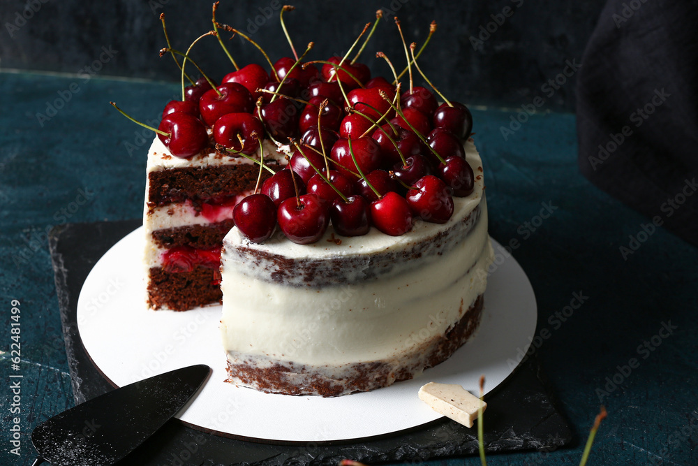 Board with tasty cherry cake on table