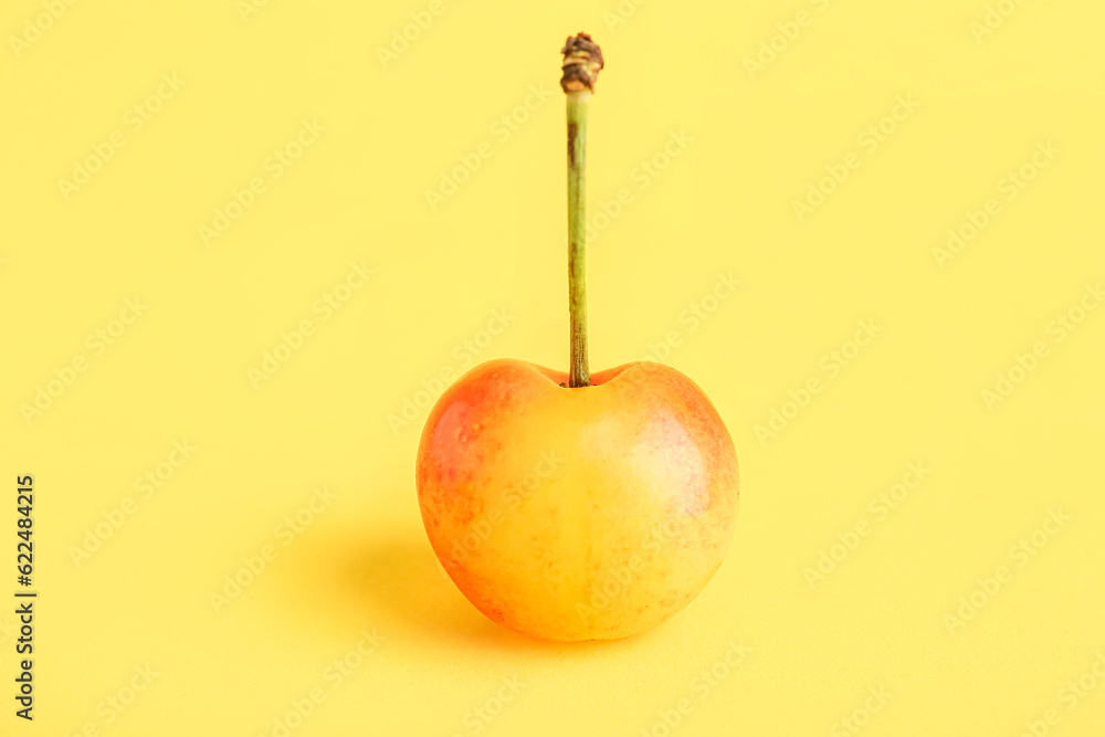 Sweet yellow cherry on color background