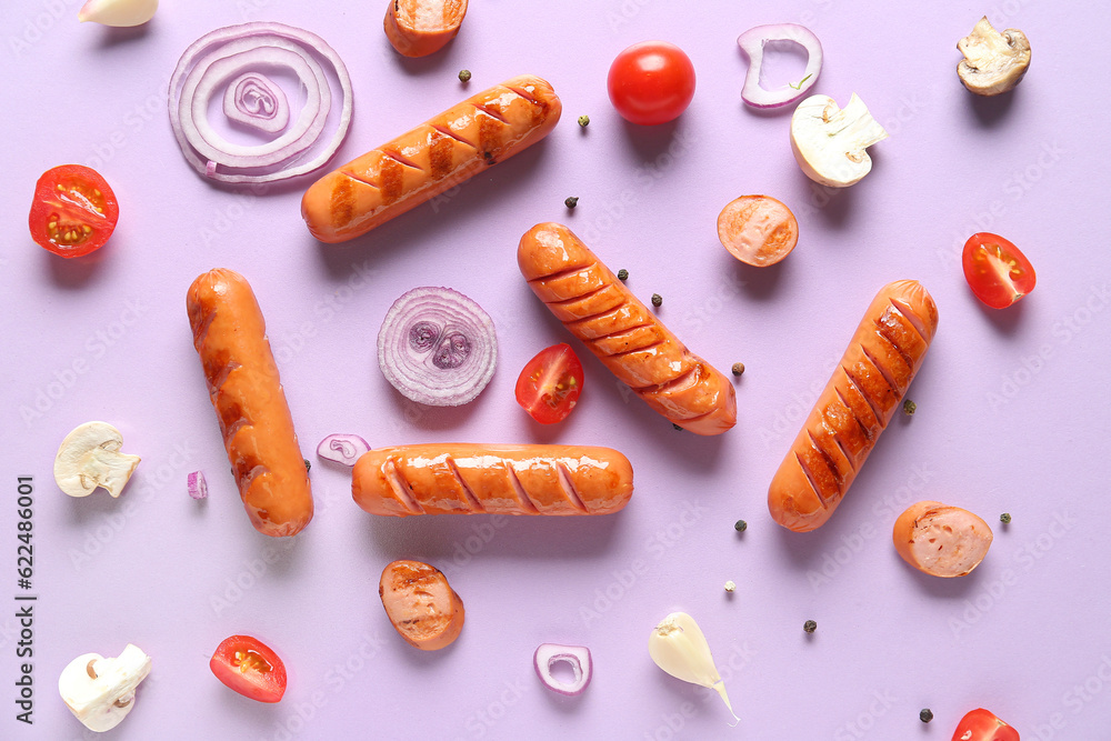 Tasty grilled sausages and vegetables on lilac background