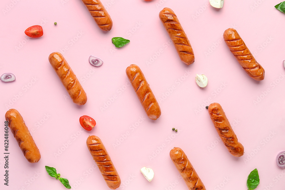 Tasty grilled sausages on pink background