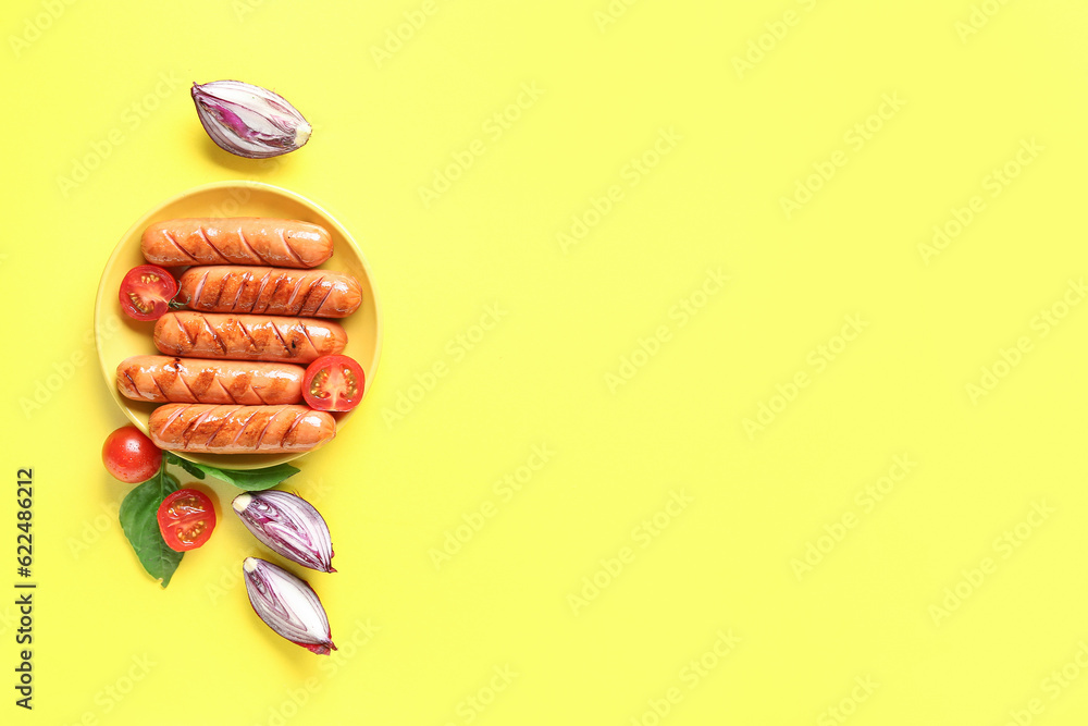 Plate with tasty grilled sausages on yellow background