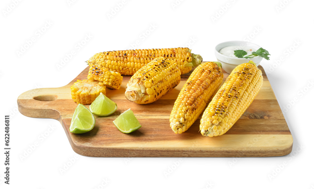 Wooden board with tasty grilled corn cobs and lime on white background