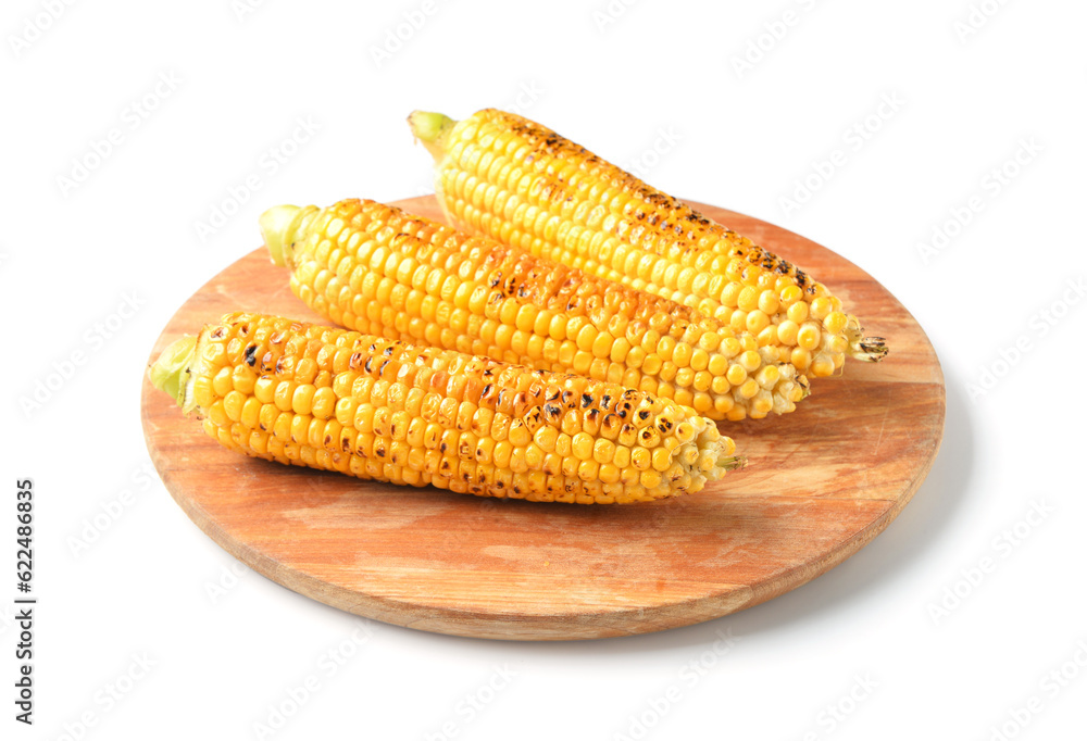 Wooden board with tasty grilled corn cobs on white background