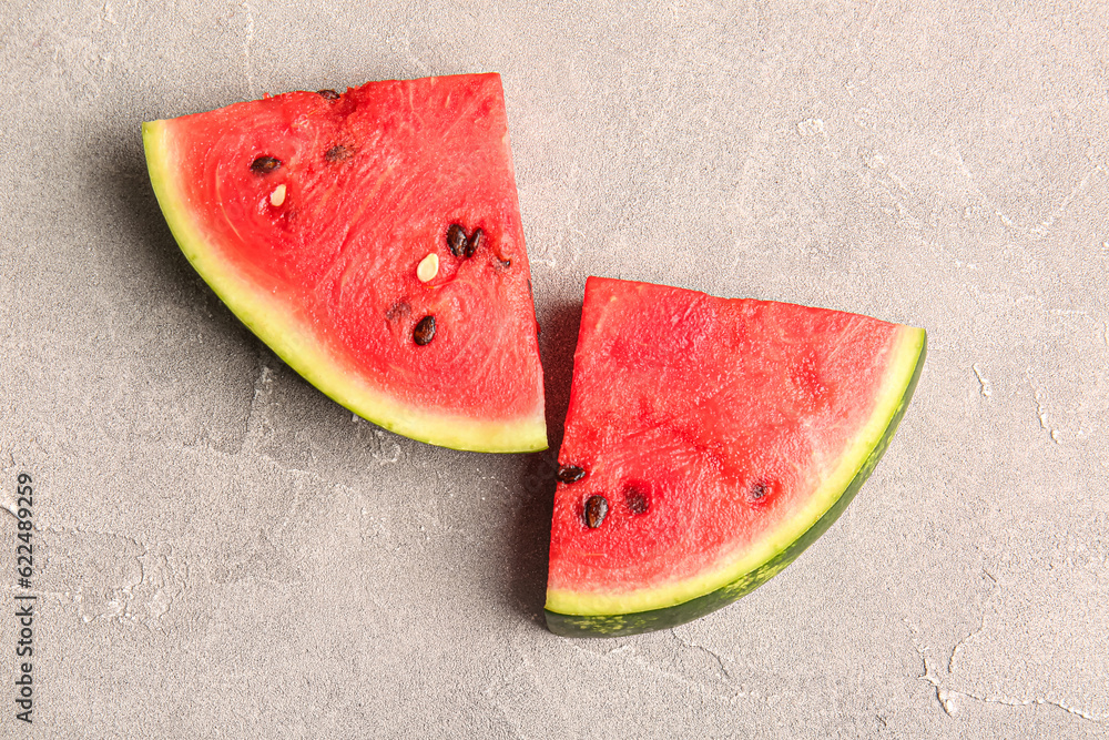 Pieces of fresh watermelon on grey table