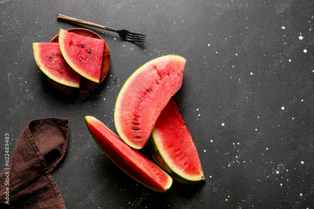 Plate with pieces of fresh watermelon on black table