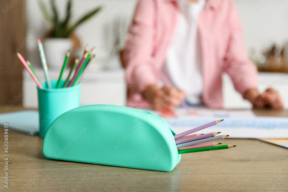 Pencil case on table in kitchen, closeup