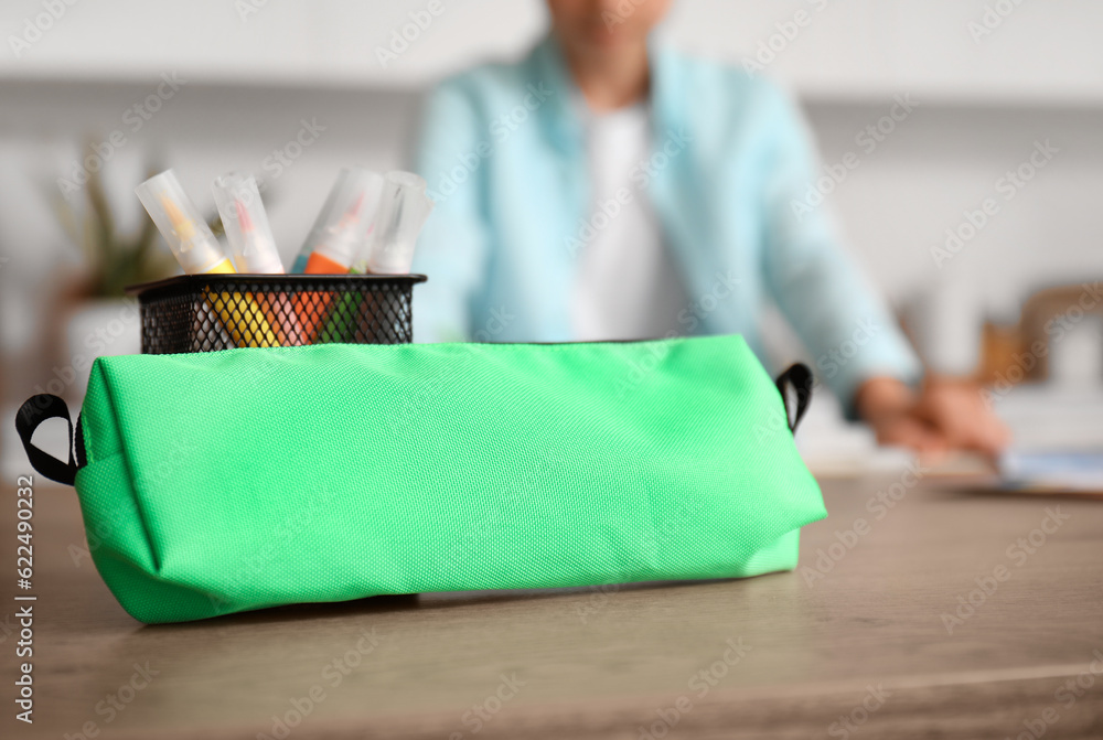 Pencil case on table in kitchen, closeup