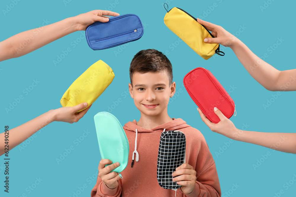 Little boy and female hands with pencil cases on blue background