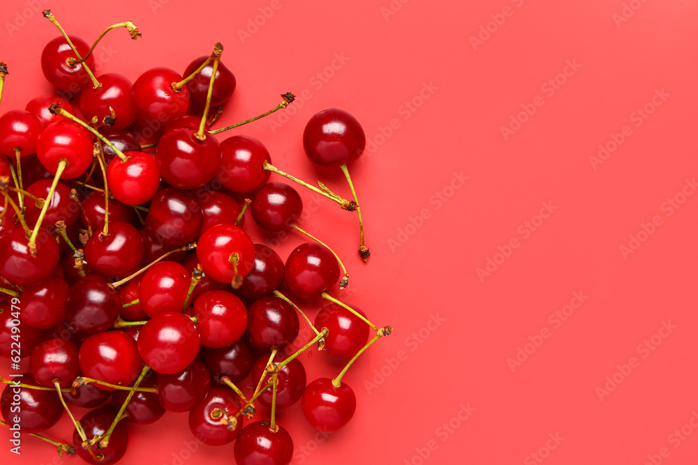 Heap of red sweet cherries on color background