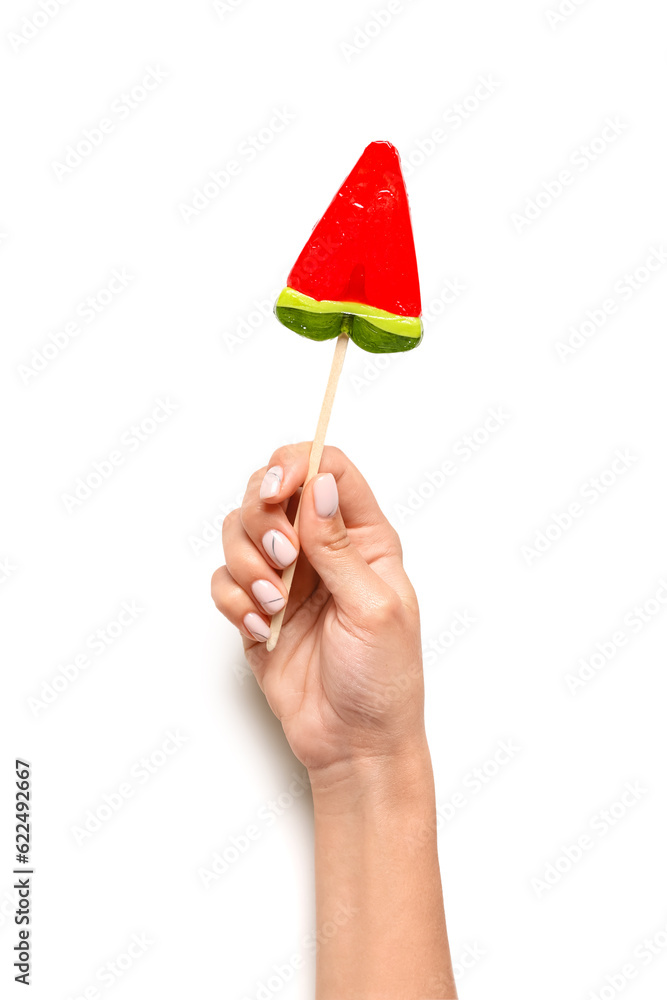 Woman holding lollipop in shape of watermelon slice on white background