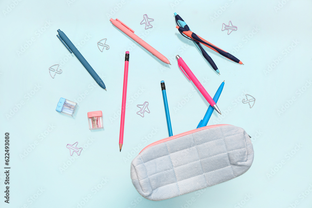 Pencil case with different stationery on blue background