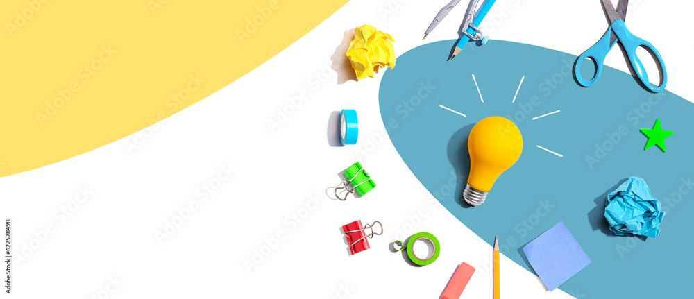 Idea light bulb with school supplies overhead view - flat lay