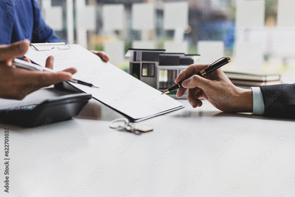 Real estate agents negotiate for businessmen to legally sign home purchase agreements contract , ren