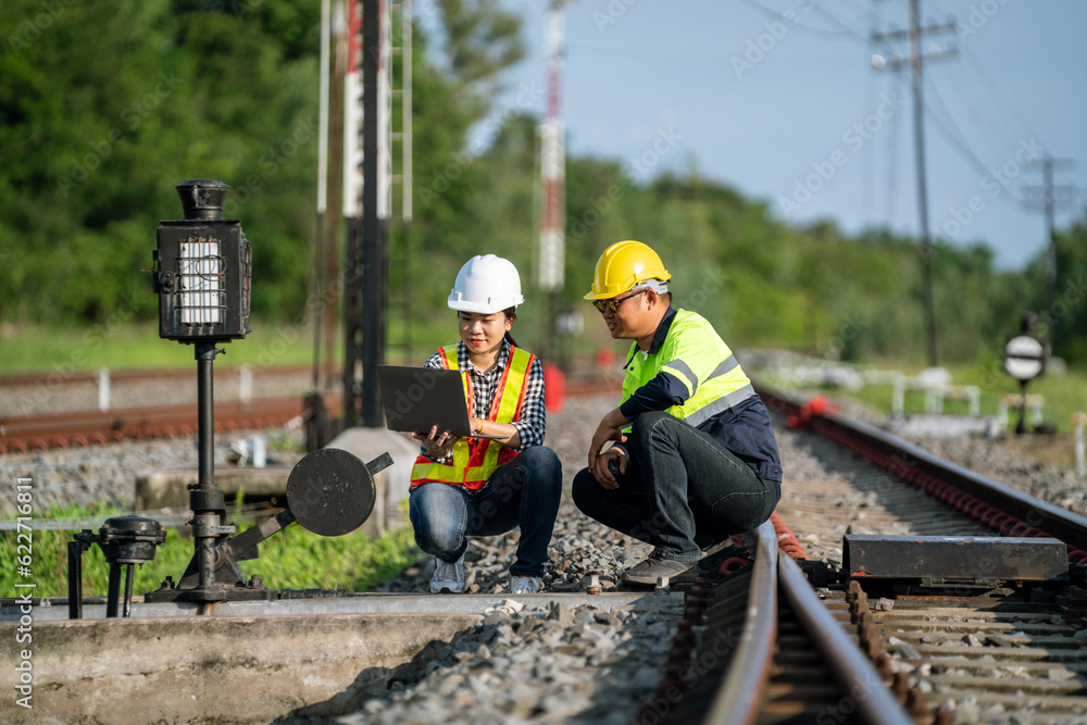 Architects and engineers work together at the railroad tracks.