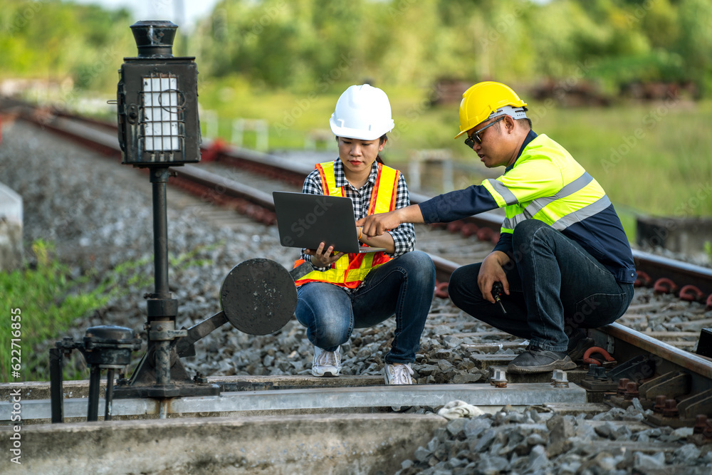 Architects and engineers sit on their laptops discussing points of rail that need to be accelerated 