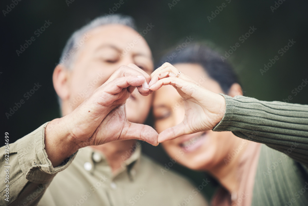 Heart, hands and a senior couple in a house for love, care and showing an emoji together. Happy, tru