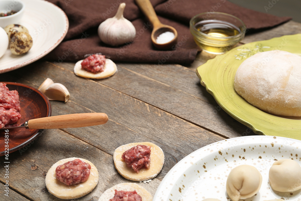 Ingredients for preparing dumplings on wooden background