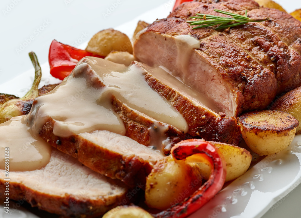 sliced roast pork with vegetables and sauce