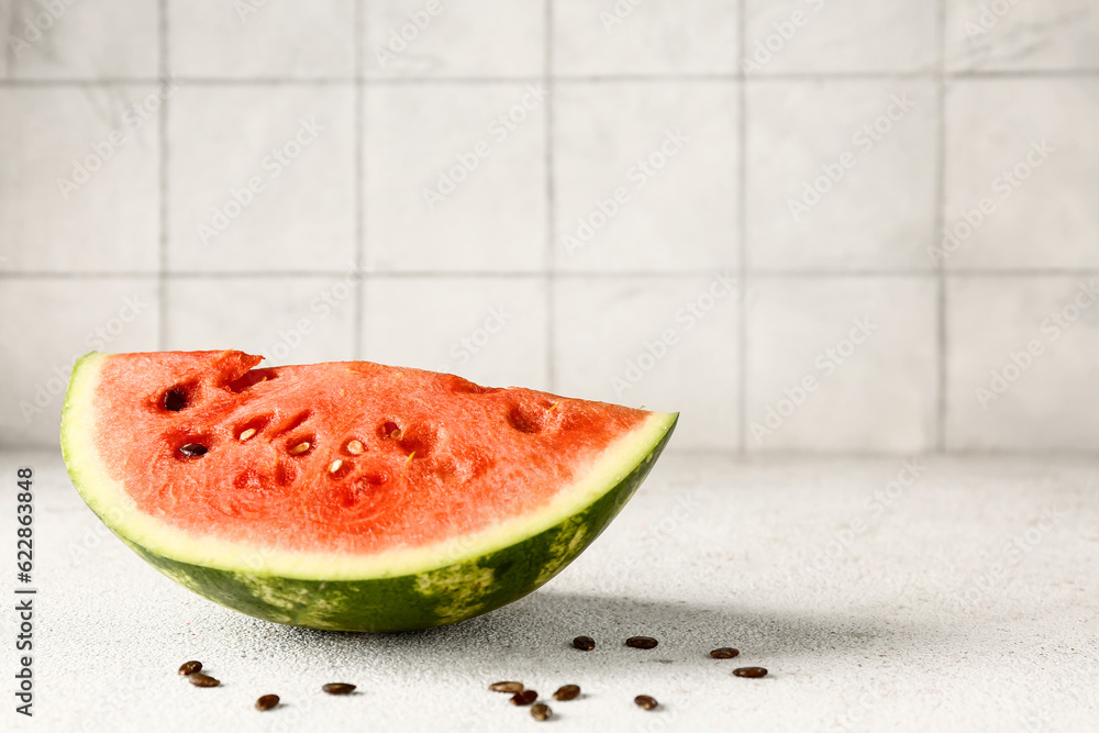 Piece of fresh watermelon and seeds on white table