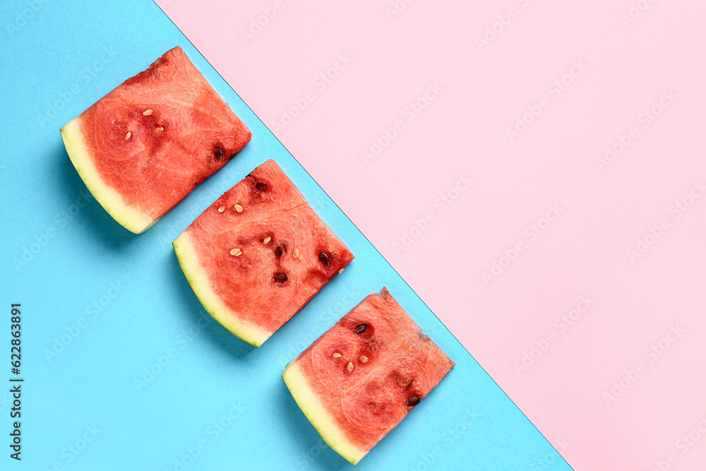 Pieces of fresh watermelon on colorful background