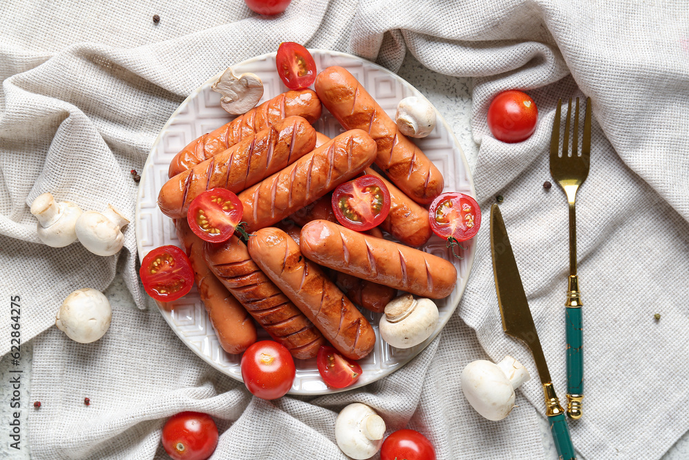 Plate with tasty grilled sausages on table