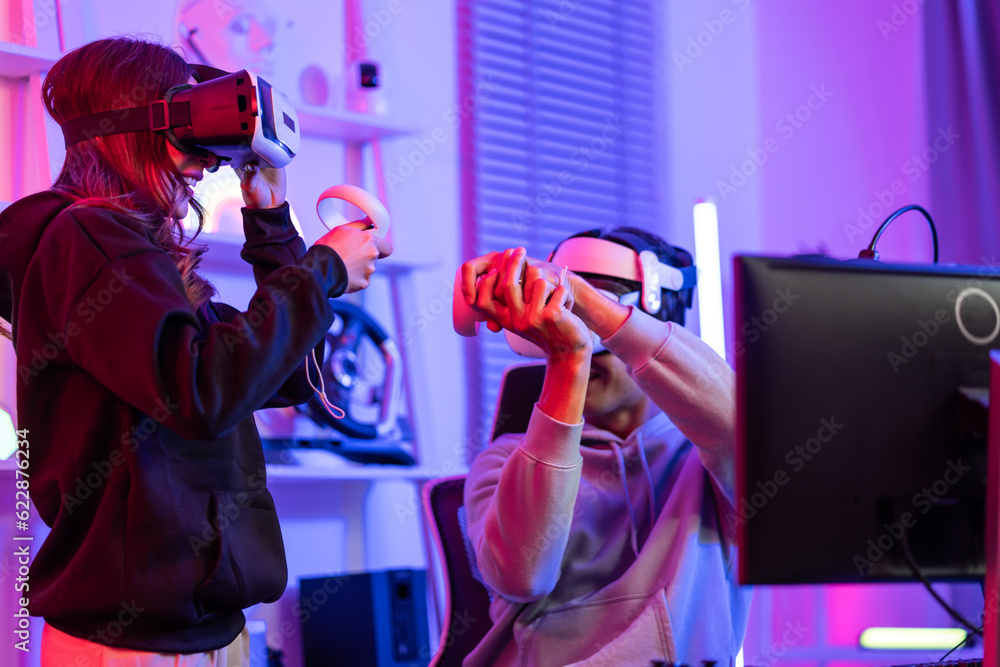 Asian young esport couple gamer use technology VR glasses play game. 