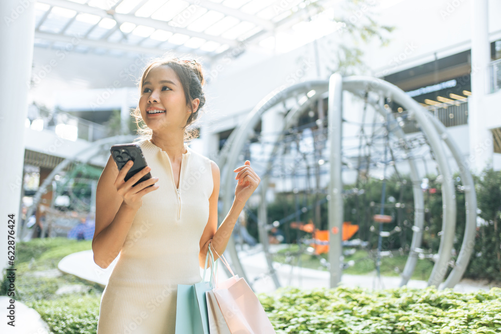 Asian beautiful woman shopping goods outdoor alone in department store. 