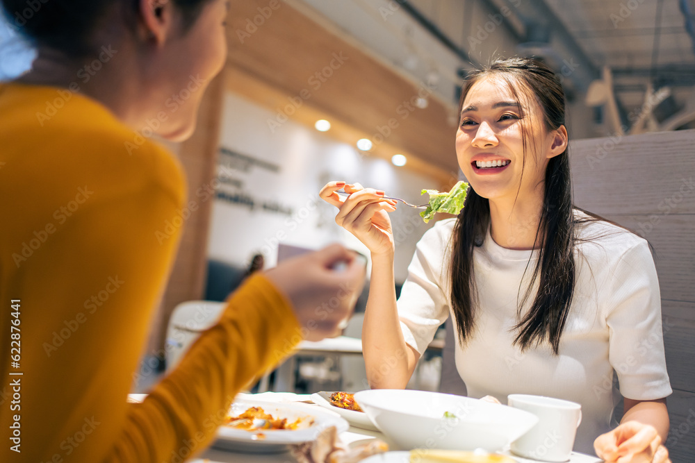 Asian beautiful women having dinner with friend in restaurant together. 