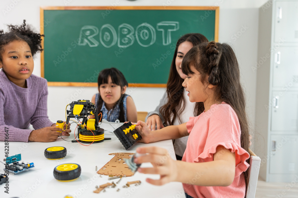 Caucasian woman teacher teaching a lesson to kids at elementary school. 