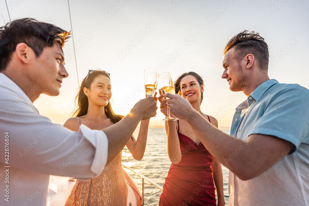 Group of diverse friends drink champagne while having a party in yacht. 