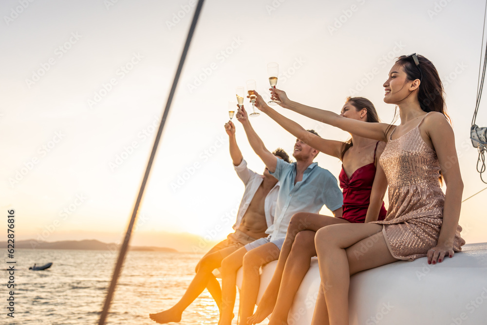 Group of diverse friends drink champagne while having a party in yacht. 