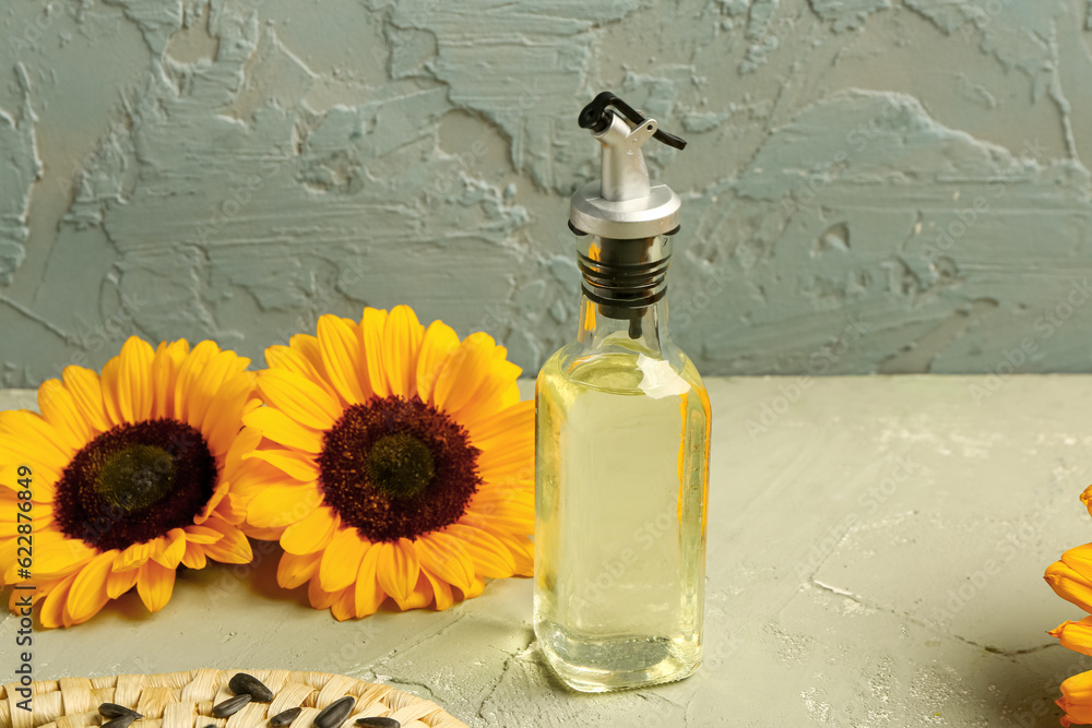 Bottle of sunflower oil on green background