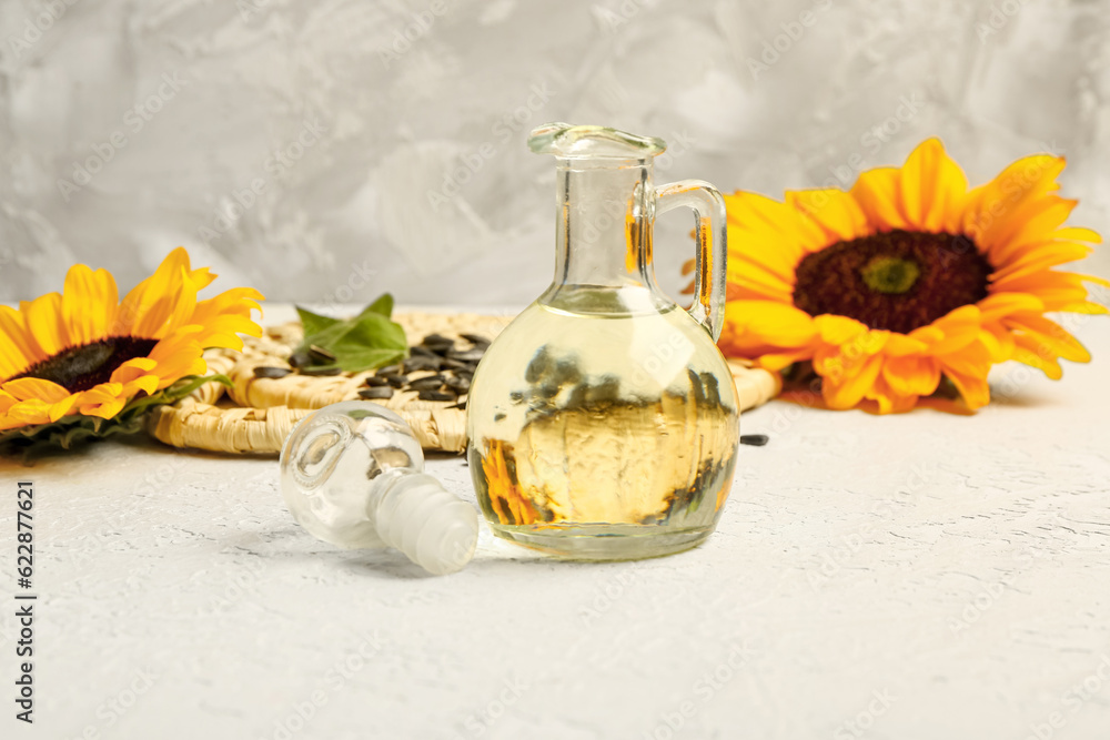 Decanter of sunflower oil on grey background