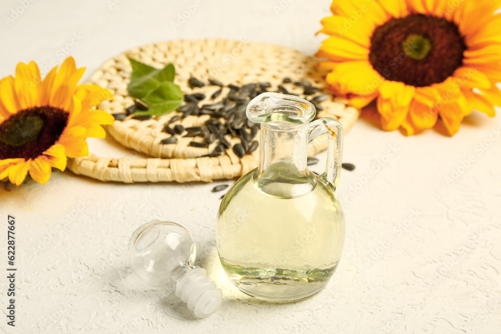 Decanter of sunflower oil on grey background