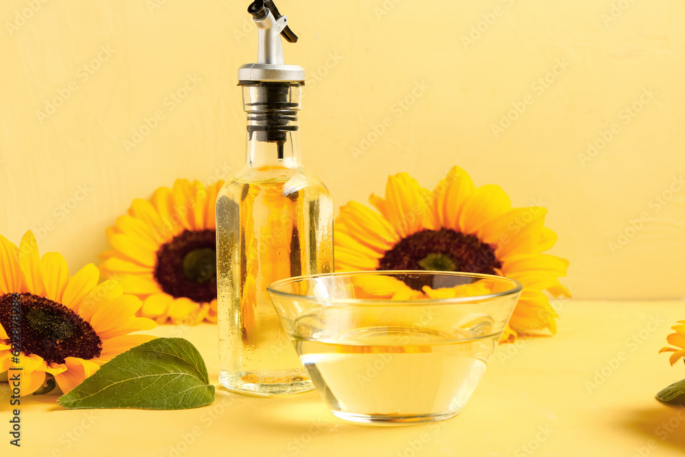 Bottle and bowl of oil on yellow background