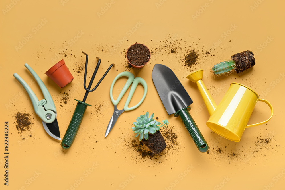 Composition with gardening tools, soil and plants on yellow background