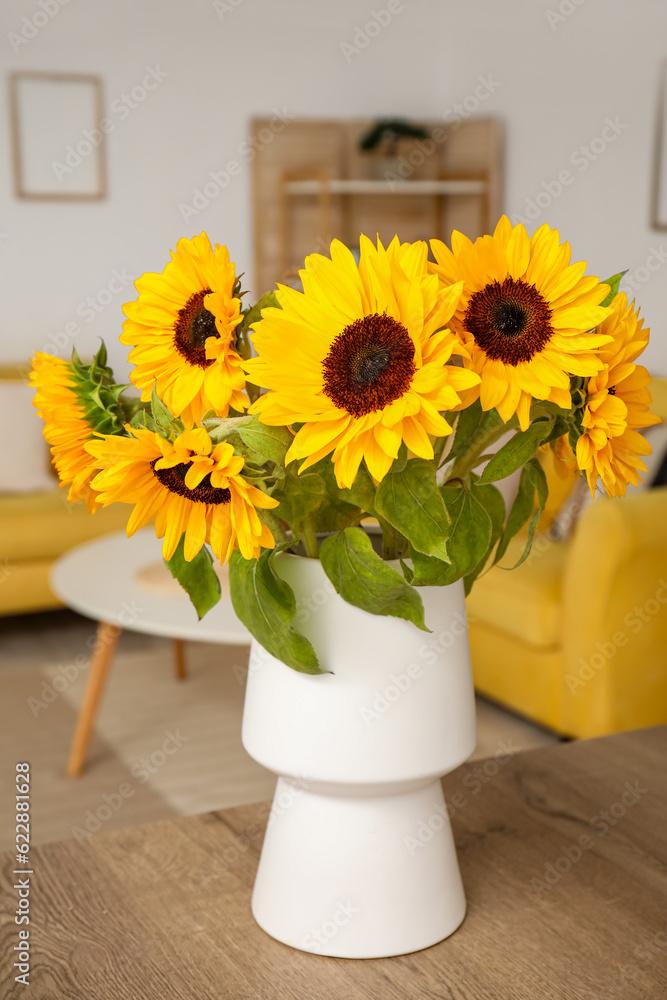 Vase with beautiful sunflowers on wooden table in kitchen, closeup