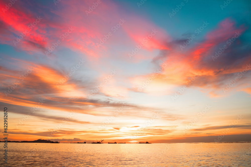 Sunset Colorful sunset at the sea. Romantic Sunet go down, blue and orange clouds flow in sky. Majes