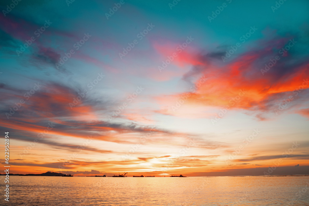 Sunset Colorful sunset at the sea. Romantic Sunet go down, blue and orange clouds flow in sky. Majes