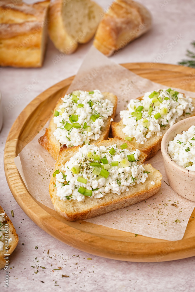 Sandwiches with tasty cottage cheese and green onion on table