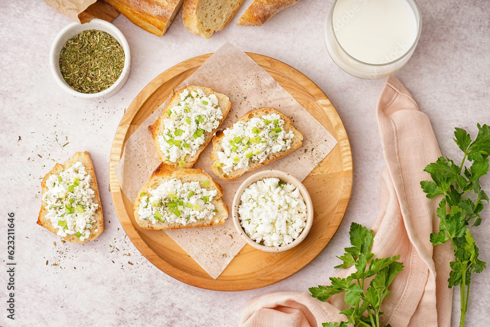 Sandwiches with tasty cottage cheese and green onion on table