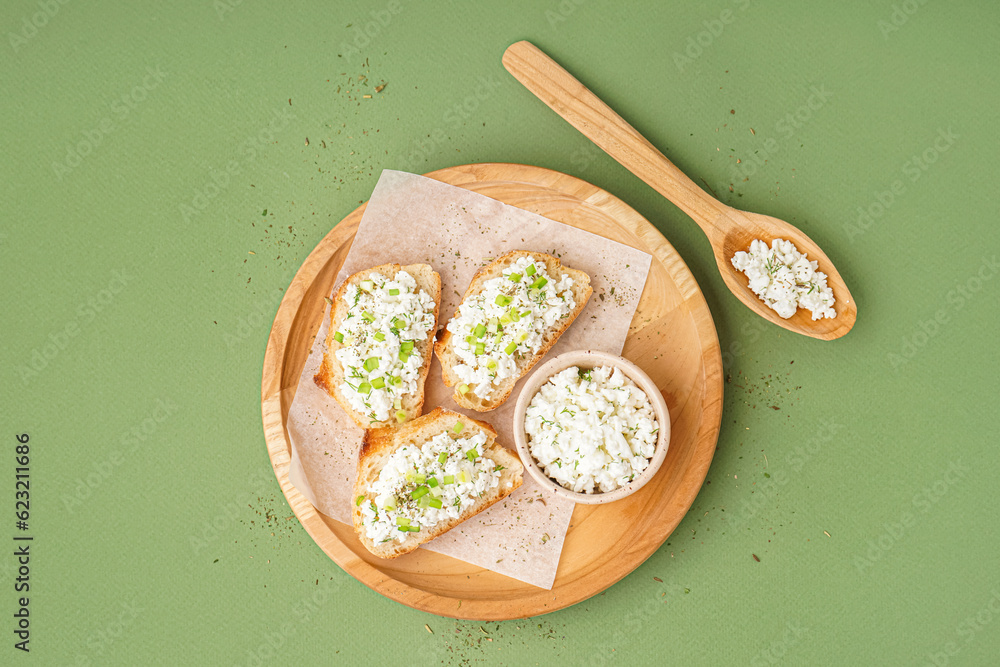 Sandwiches with tasty cottage cheese and green onion on color background