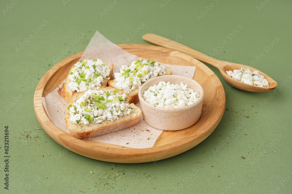 Sandwiches with tasty cottage cheese and green onion on color background